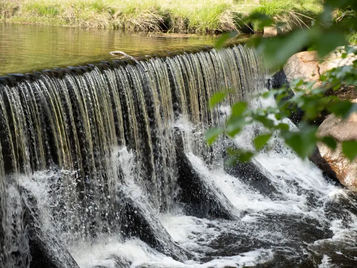 Water tumbling over a small weir.